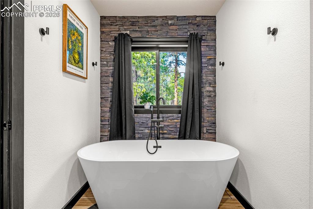 15520 Bar X Road Colorado Springs, CO 80908 - Photo 26 of 50 a white bath tub sitting in a bathroom