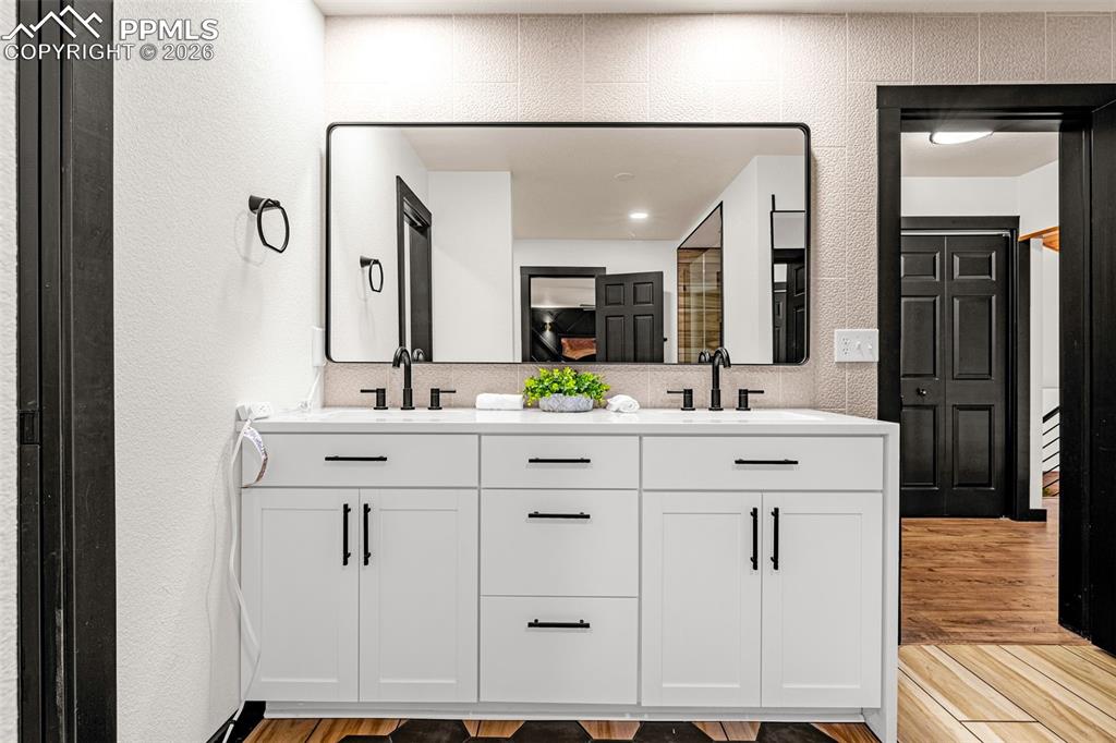 15520 Bar X Road Colorado Springs, CO 80908 - Photo 27 of 50 a bathroom with a double vanity sink mirror and double