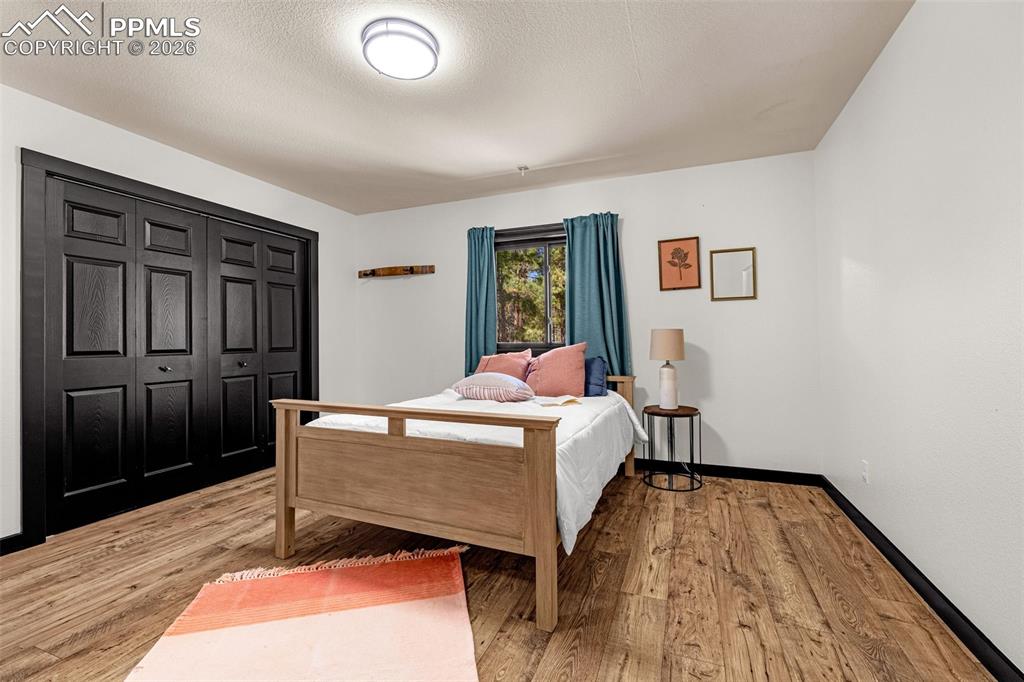 15520 Bar X Road Colorado Springs, CO 80908 - Photo 28 of 50 a bed room with a bed and a dresser