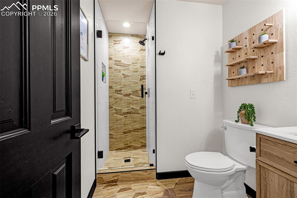 15520 Bar X Road Colorado Springs, CO 80908 - Photo 31 of 50 a bathroom with a toilet and a shower