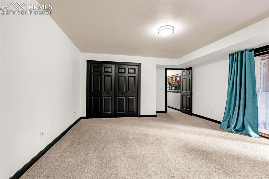 15520 Bar X Road Colorado Springs, CO 80908 - Photo 33 of 50 an empty room with closet