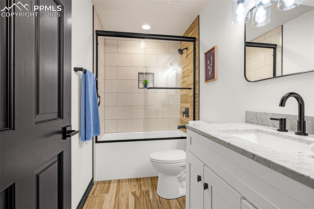 15520 Bar X Road Colorado Springs, CO 80908 - Photo 34 of 50 a bathroom with a granite countertop sink toilet and shower