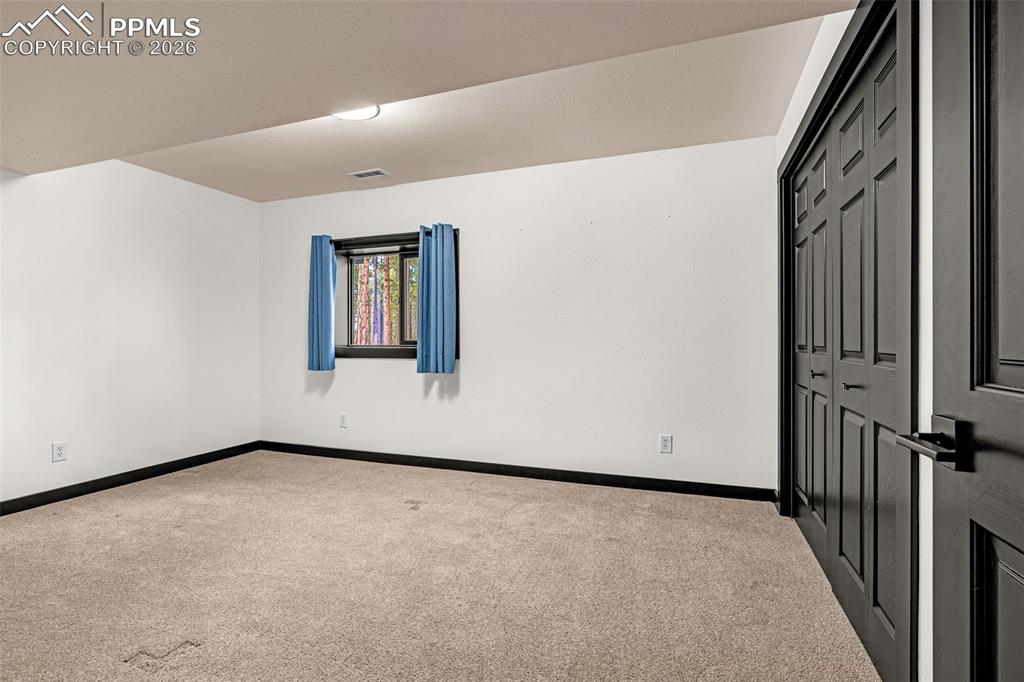 15520 Bar X Road Colorado Springs, CO 80908 - Photo 35 of 50 an empty room with windows