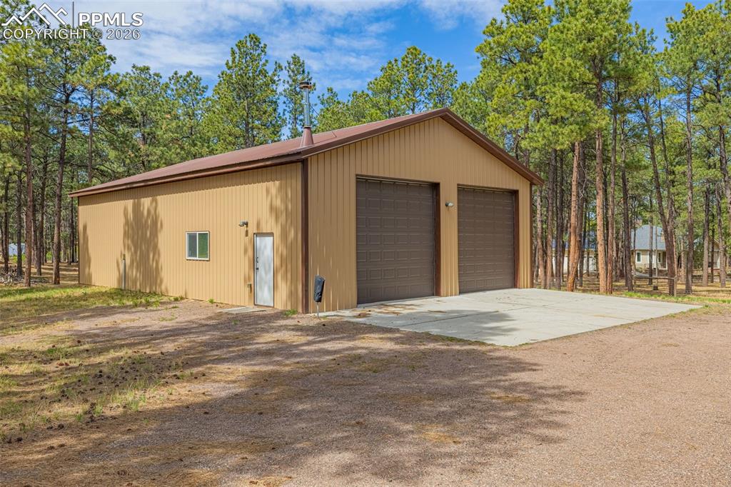 15520 Bar X Road Colorado Springs, CO 80908 - Photo 44 of 50 a view of a house with a backyard and road