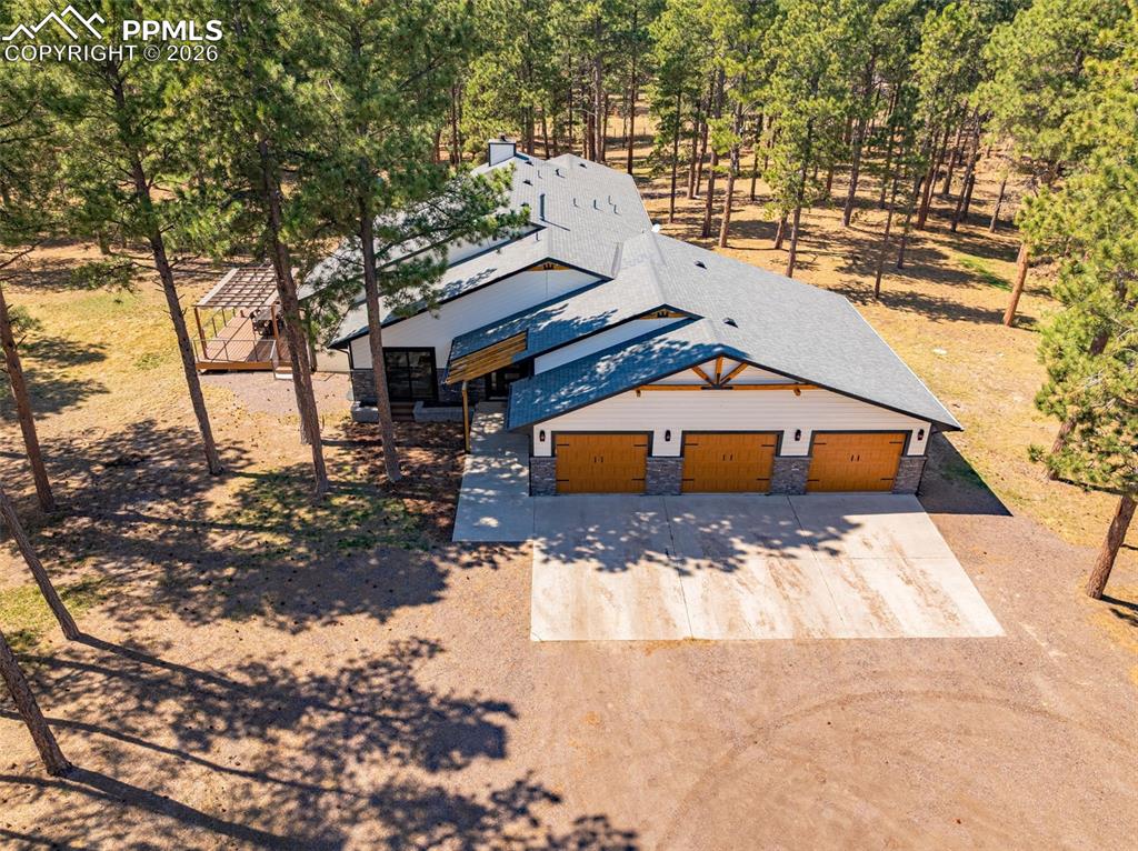 15520 Bar X Road Colorado Springs, CO 80908 - Photo 48 of 50 a view of a house with a yard