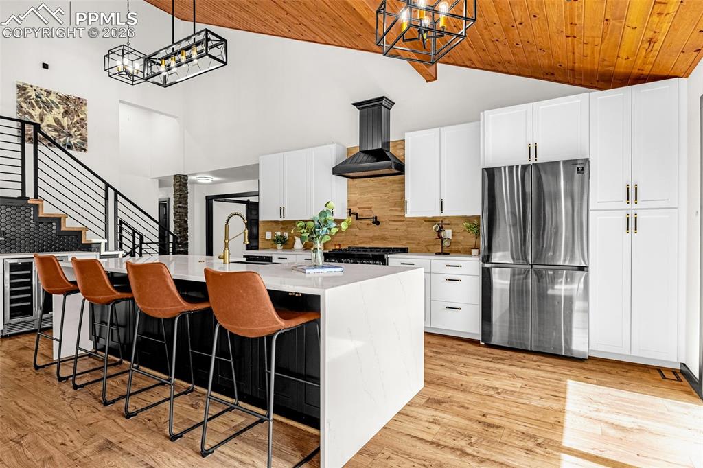 15520 Bar X Road Colorado Springs, CO 80908 - Photo 8 of 50 a kitchen with stainless steel appliances granite countertop a refrigerator a stove a sink and chairs