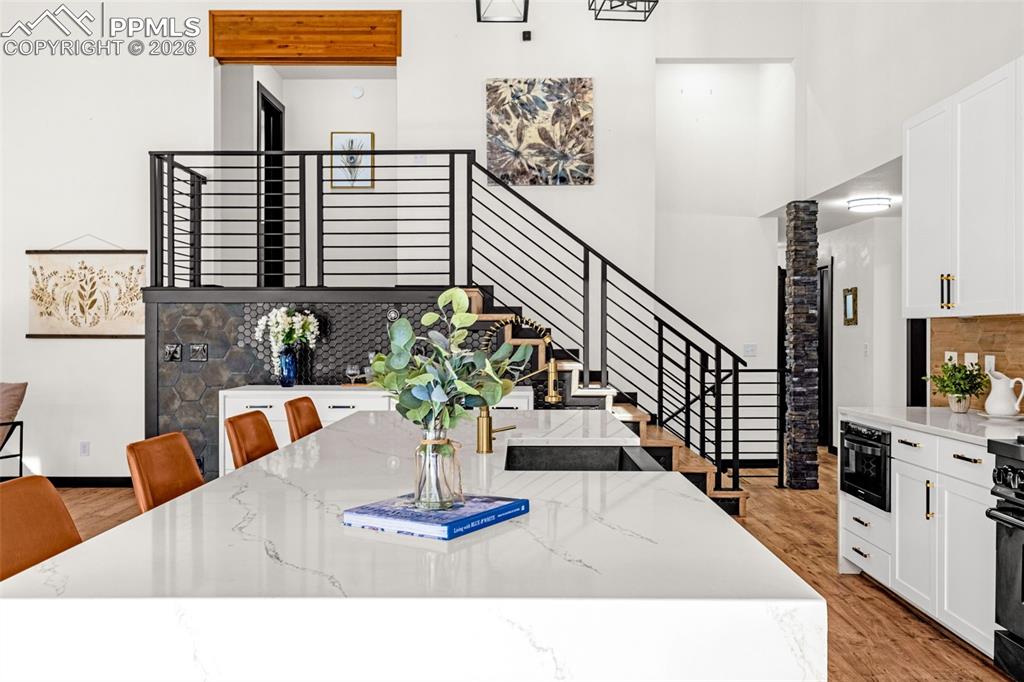 15520 Bar X Road Colorado Springs, CO 80908 - Photo 9 of 50 a living room with furniture flowerpot and wooden floor