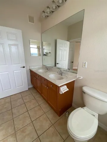a bathroom with a sink a toilet and mirror