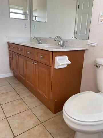 a bathroom with a sink a toilet and mirror