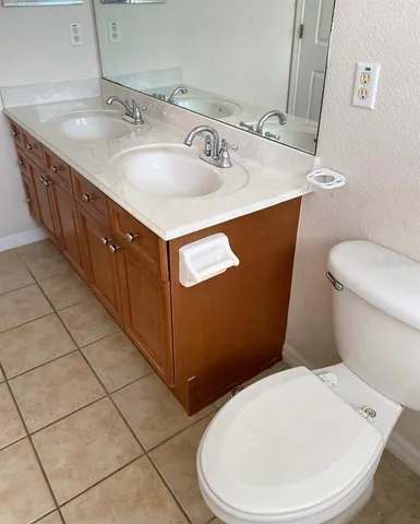 a bathroom with a sink a toilet and mirror