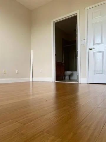 a view of a room with wooden floor