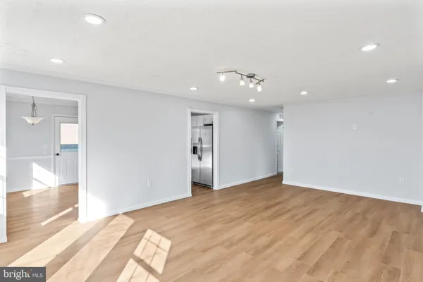 a view of a room with wooden floor and windows