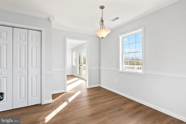a kitchen with cabinets stainless steel appliances a sink and a window