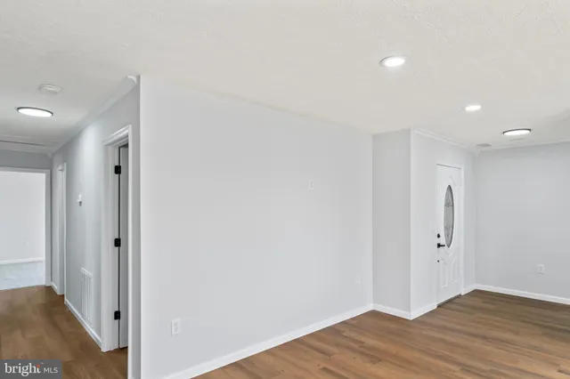 an empty room with windows and closet