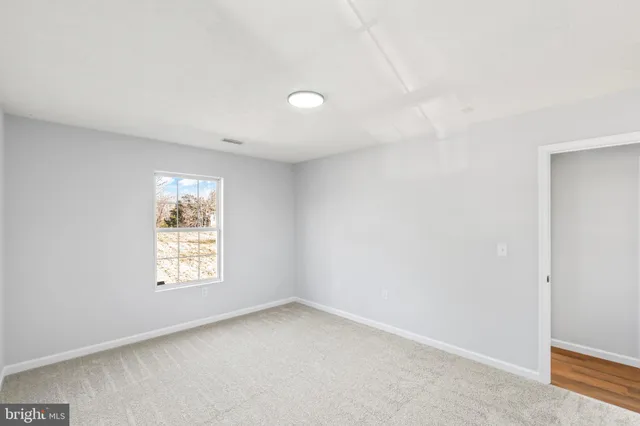 a view of a house with a wooden fence