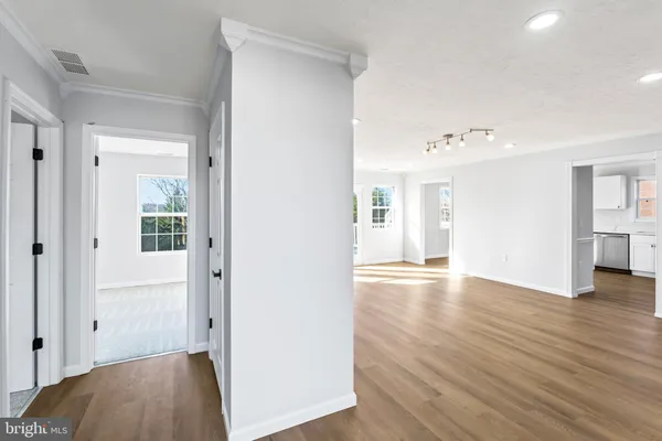 a view of an empty room with wooden floor