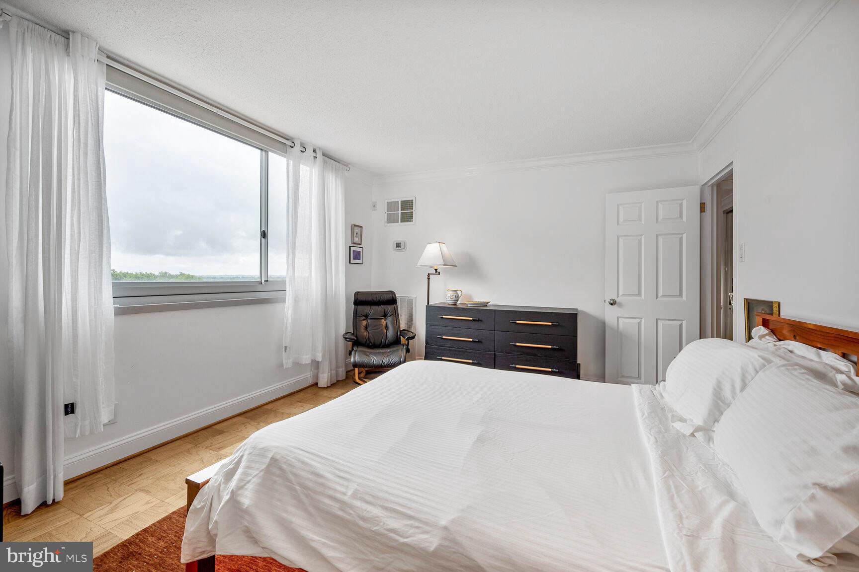 4601 North Park Avenue, Unit 1118 Chevy Chase, MD 20815 - Photo 15 of 30 a bedroom with a bed and a window