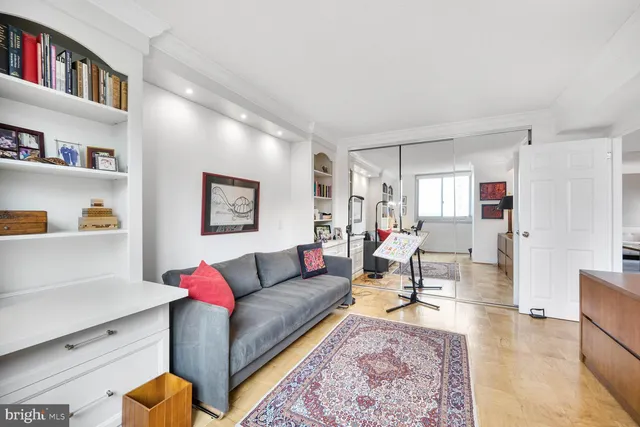 a living room with furniture and a book shelf