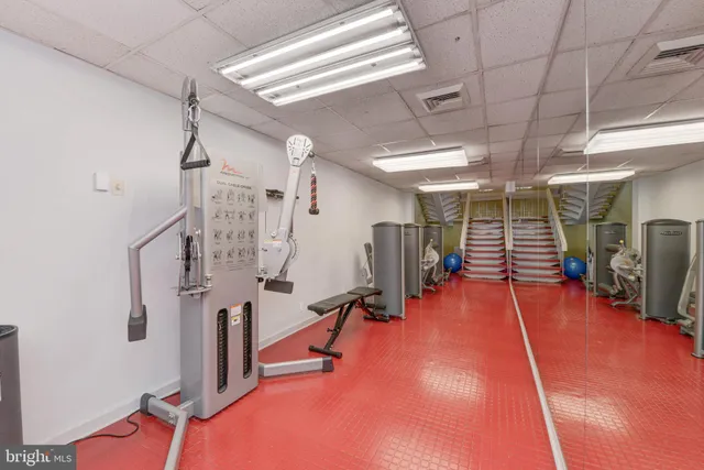 a room with gym equipment and mirror