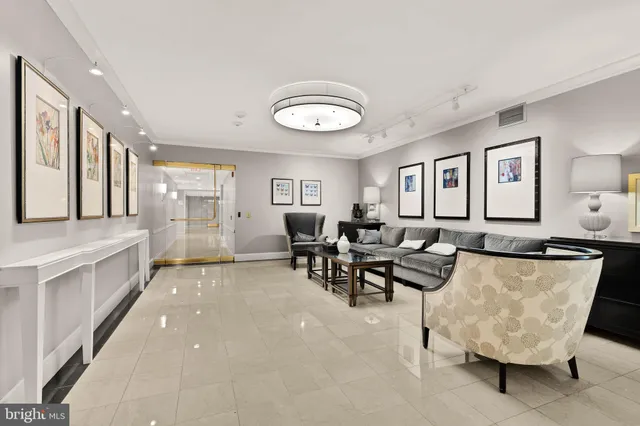 a view of a dining room and livingroom with furniture a rug and a painting