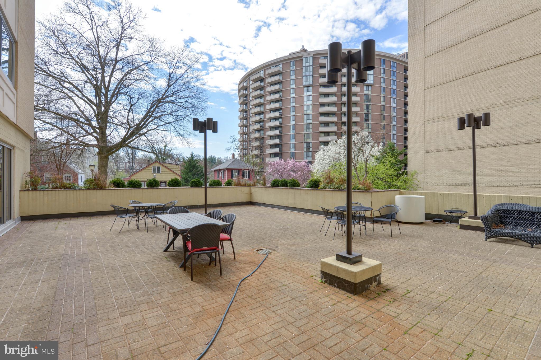 4601 North Park Avenue, Unit 1118 Chevy Chase, MD 20815 - Photo 27 of 30 a view of a patio with a table and chairs