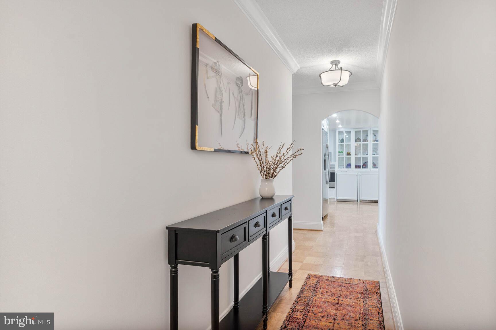 4601 North Park Avenue, Unit 1118 Chevy Chase, MD 20815 - Photo 4 of 30 a view of a hallway with wooden floor and entryway