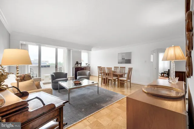 a living room with furniture a dining table and a flat screen tv