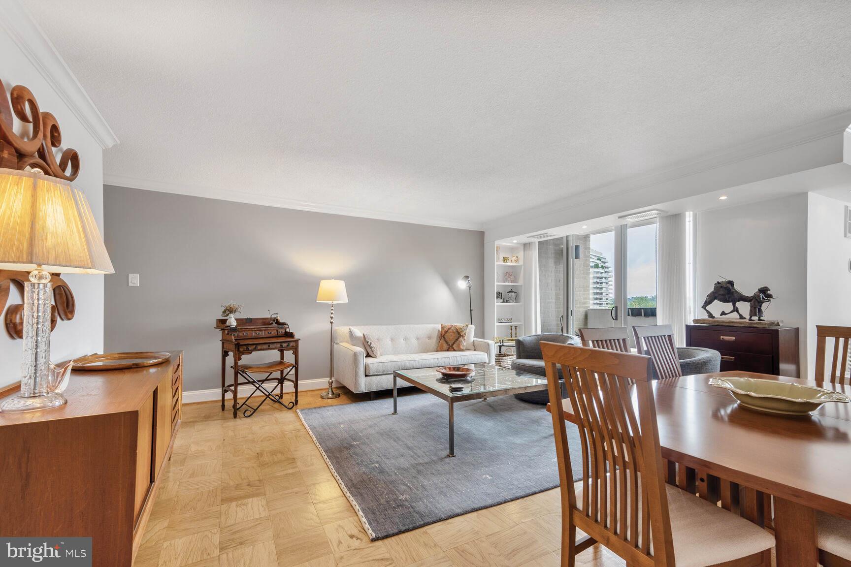 4601 North Park Avenue, Unit 1118 Chevy Chase, MD 20815 - Photo 6 of 30 a living room with furniture a dining table and a flat screen tv
