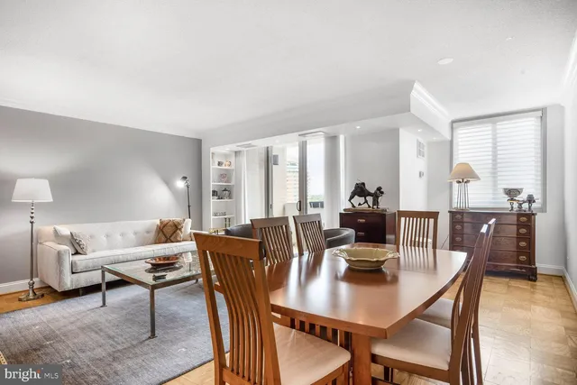 a dining room with furniture and wooden floor