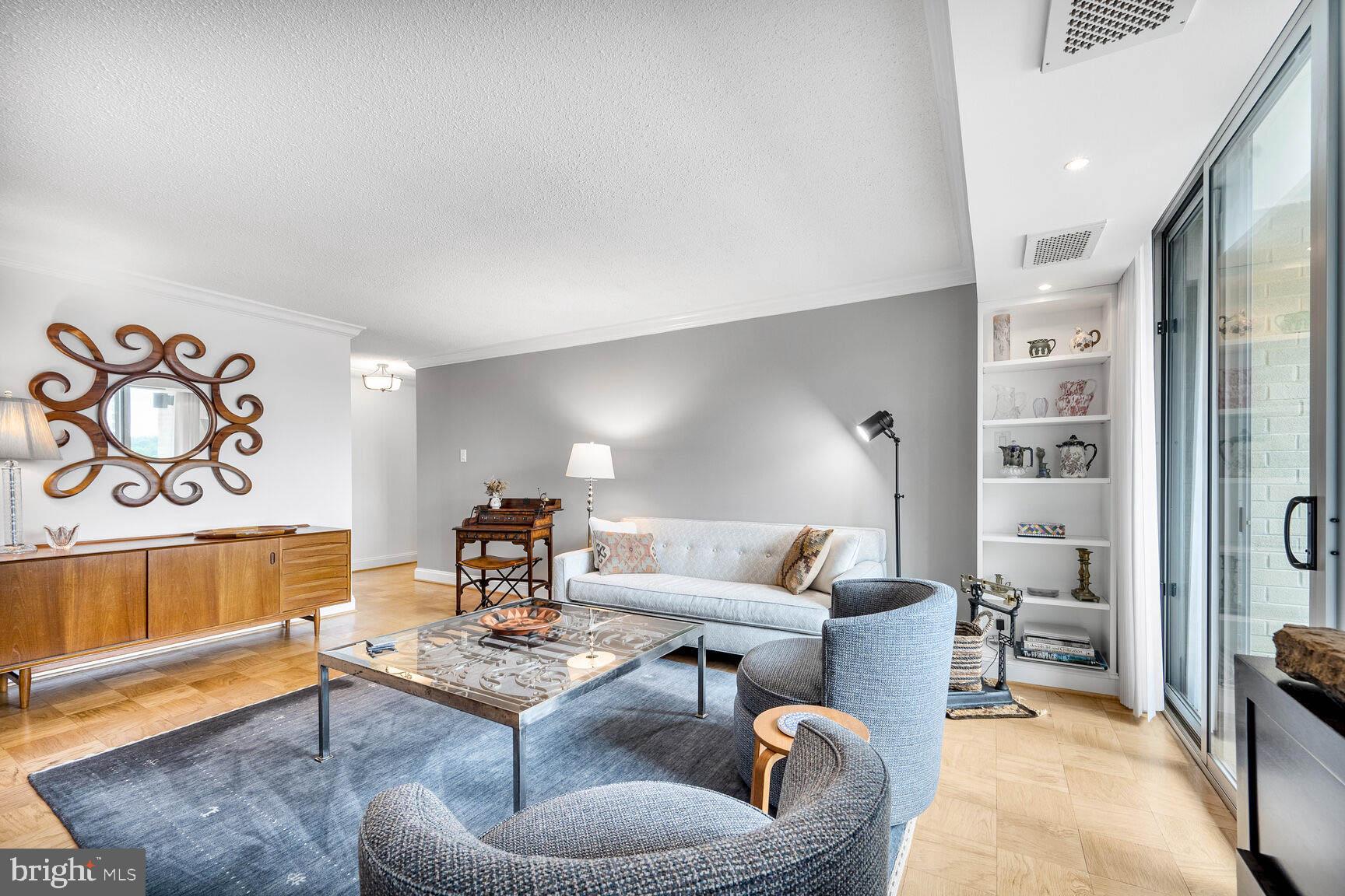 4601 North Park Avenue, Unit 1118 Chevy Chase, MD 20815 - Photo 9 of 30 a living room with furniture and a rug