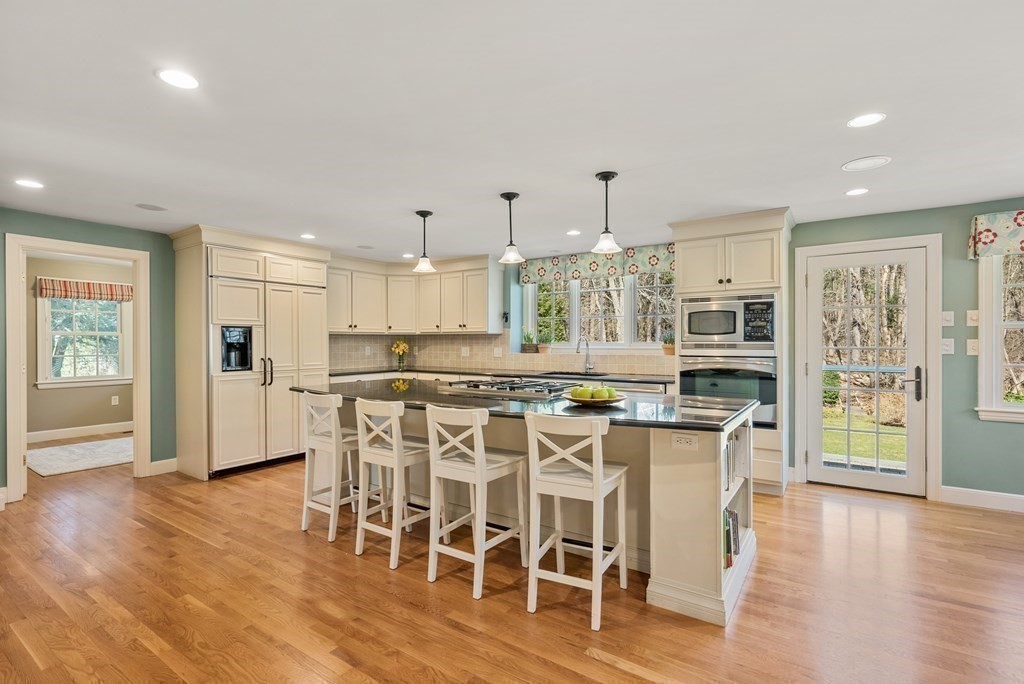 10 Meadowbrook Road Wellesley, MA 02481 - Photo 7 of 40 a kitchen with stainless steel appliances kitchen island wooden floors and white cabinets