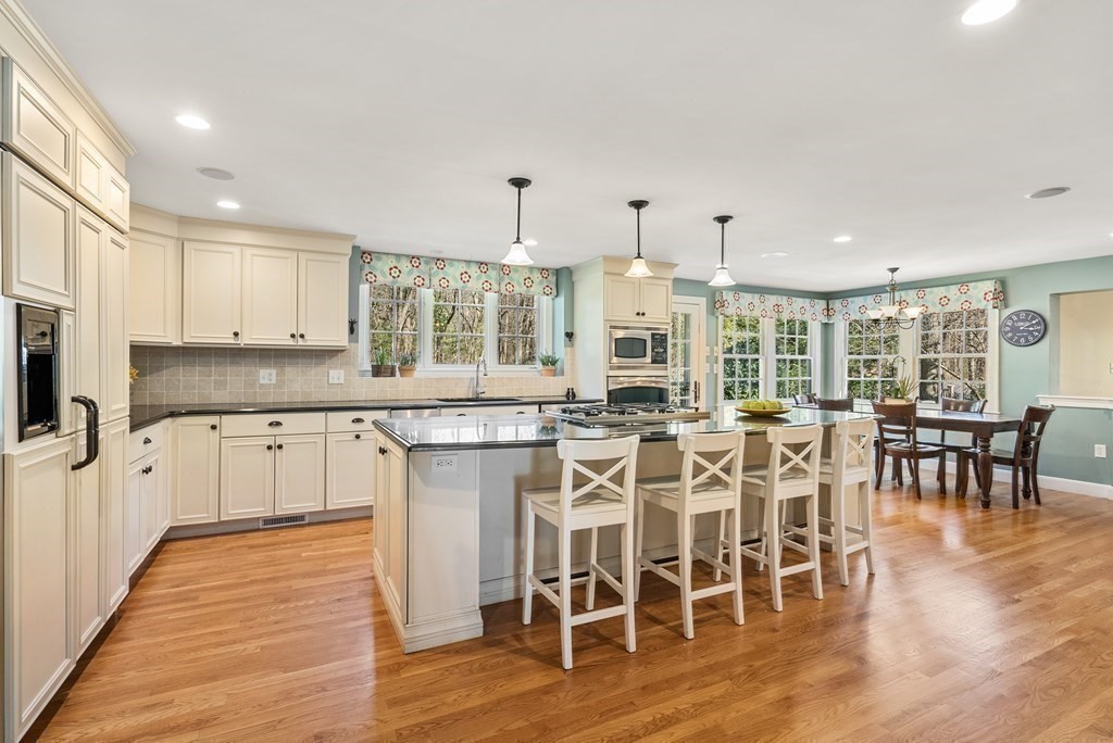 10 Meadowbrook Road Wellesley, MA 02481 - Photo 8 of 40 a large kitchen with cabinets chairs and wooden floor