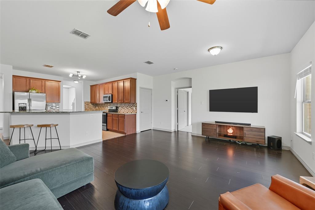 308 Sheridan Road Oak Point, TX 75068 - Photo 11 of 32 Open concept living area open to kitchen with windows providing full view of expansive backyard