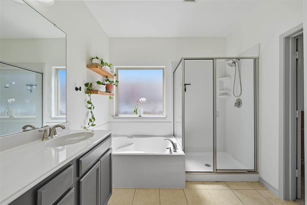 308 Sheridan Road Oak Point, TX 75068 - Photo 16 of 32 Full bathroom featuring vanity, light tile patterned floors, a stall shower, and a bath