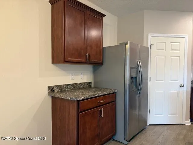 a kitchen with stainless steel appliances granite countertop a refrigerator and a sink