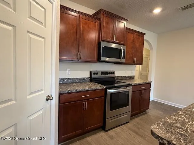 a kitchen with a stove microwave and sink