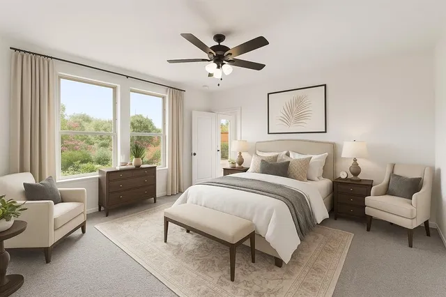 an empty room with a window and ceiling fan