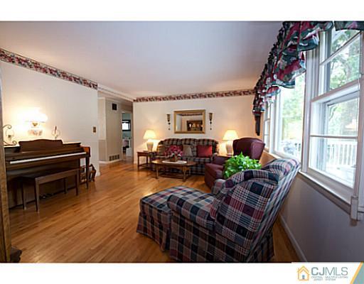 29 Orchard Road Middlesex, NJ 08846 - Photo 2 of 25 a living room with furniture a piano and wooden floor