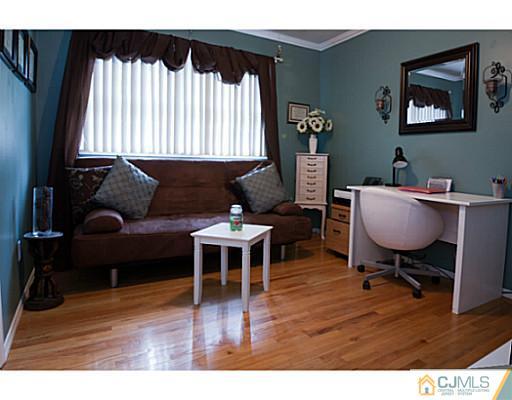 29 Orchard Road Middlesex, NJ 08846 - Photo 11 of 25 a living room with furniture wooden floor and a window