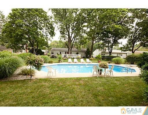 29 Orchard Road Middlesex, NJ 08846 - Photo 18 of 25 a view of house with swimming pool and yard
