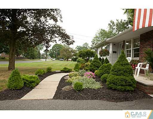 29 Orchard Road Middlesex, NJ 08846 - Photo 25 of 25 a backyard of a house with a garden and outdoor seating