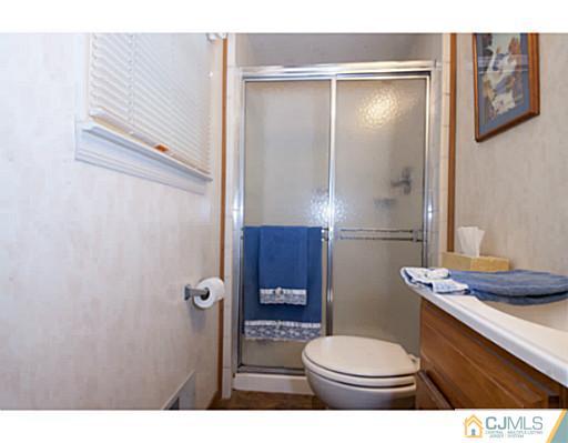 29 Orchard Road Middlesex, NJ 08846 - Photo 6 of 25 a bathroom with a toilet a sink and shower