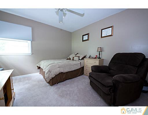 29 Orchard Road Middlesex, NJ 08846 - Photo 7 of 25 a bedroom with a bed couch and window