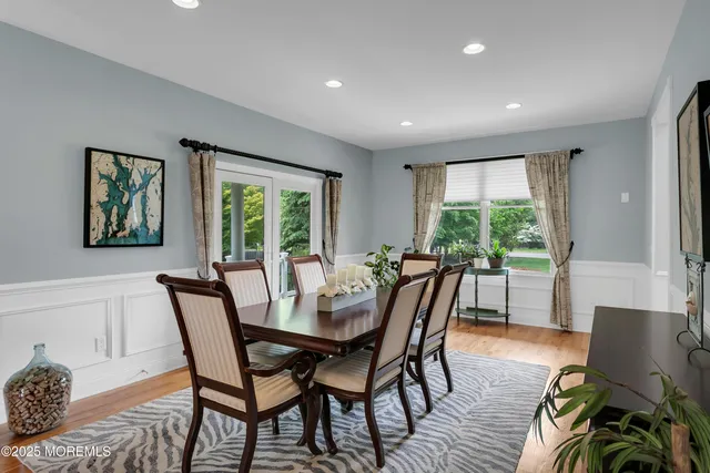 a kitchen with stainless steel appliances granite countertop a stove refrigerator and chairs