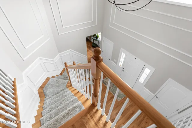 a bedroom with furniture and a large window