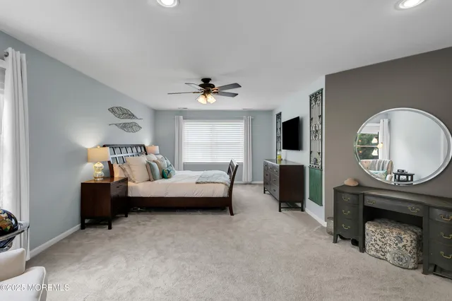 a bedroom with furniture and a large window