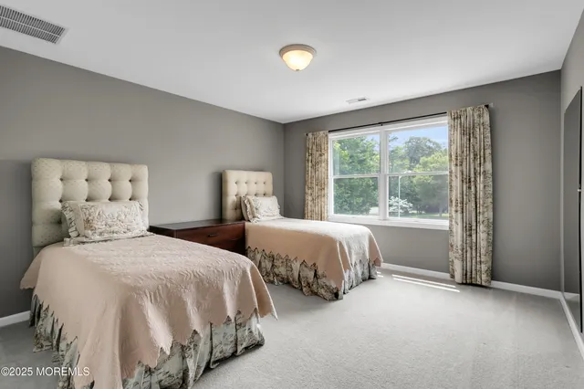 a view of a patio with couches chairs and floor to ceiling window and potted plants