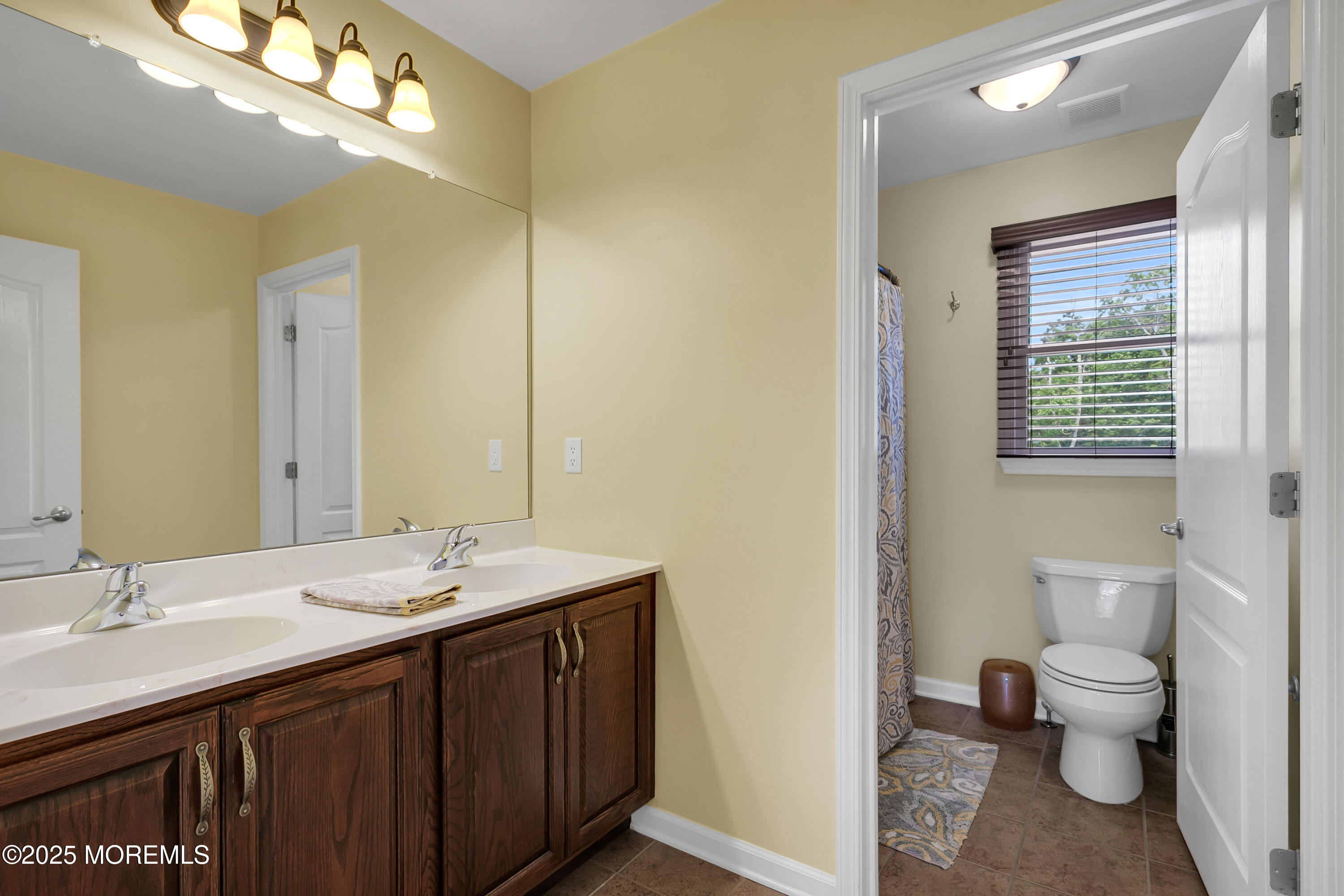 529 Woodview Road Toms River, NJ 08755 - Photo 39 of 85 a bathroom with a sink a toilet and a mirror