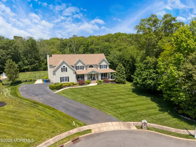 an aerial view of a house with a garden and yard
