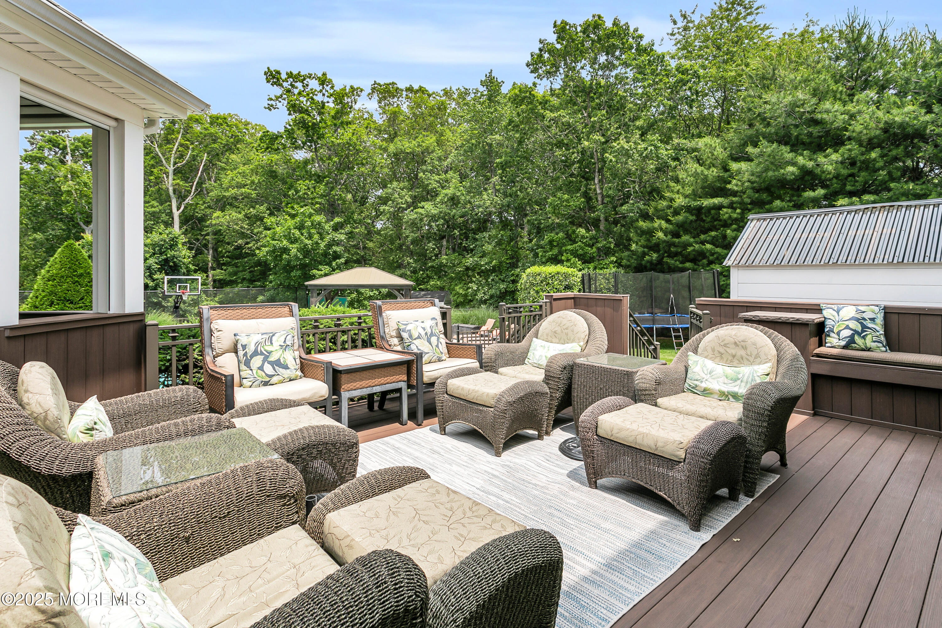 529 Woodview Road Toms River, NJ 08755 - Photo 56 of 85 a view of a patio with couches chairs and wooden floor